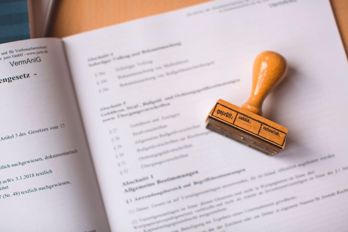 A rubber stamp resting on a checked document